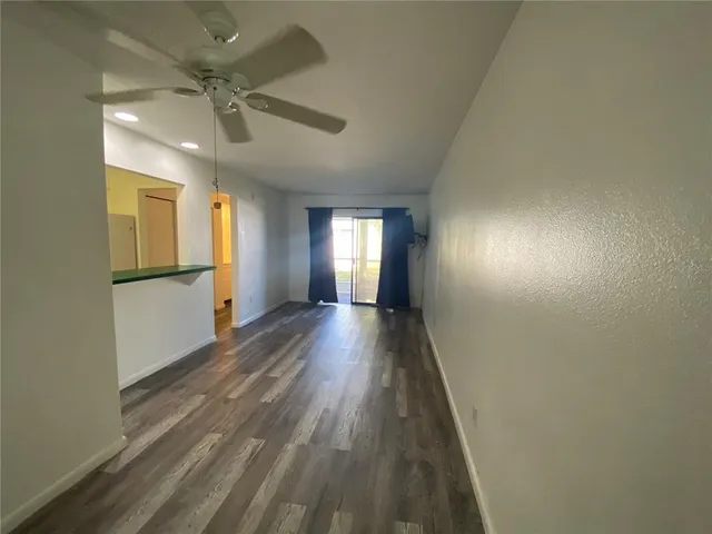 a view of a room with wooden floor and sink