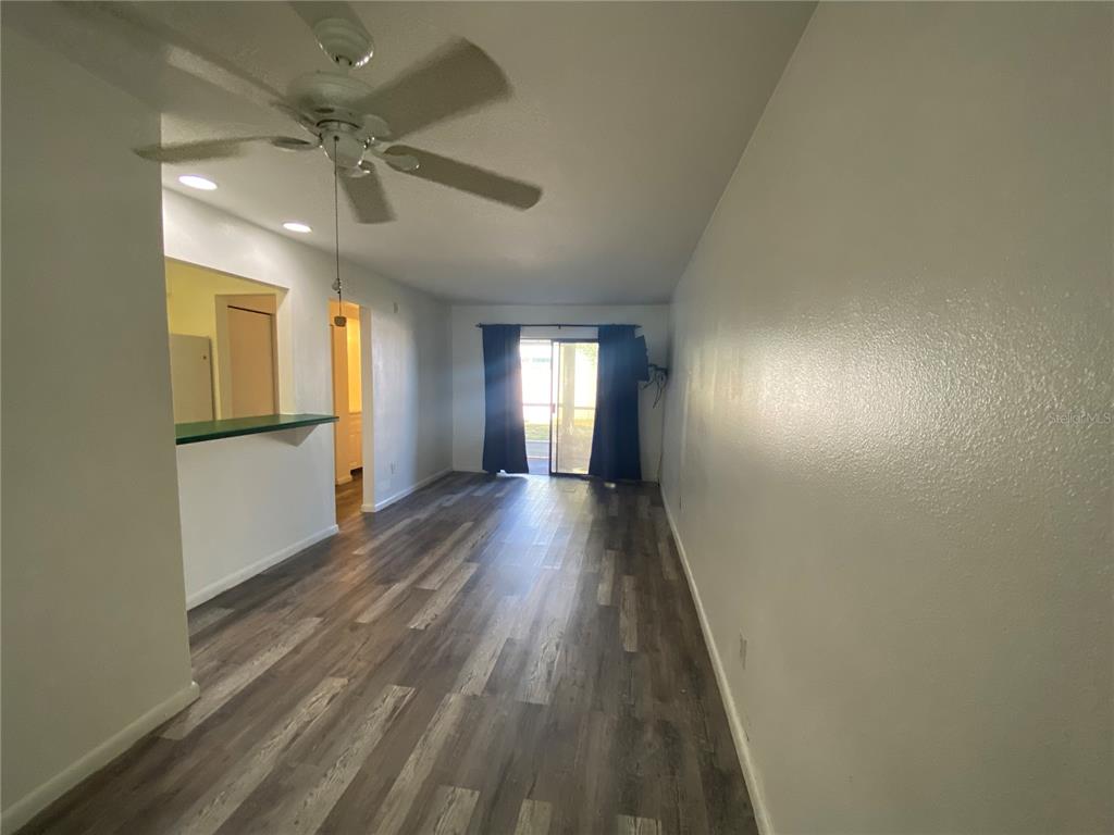 22302 Vick Street, Unit 112 Punta Gorda, FL 33980 - Photo 7 of 10 wooden floor in an empty room with a window