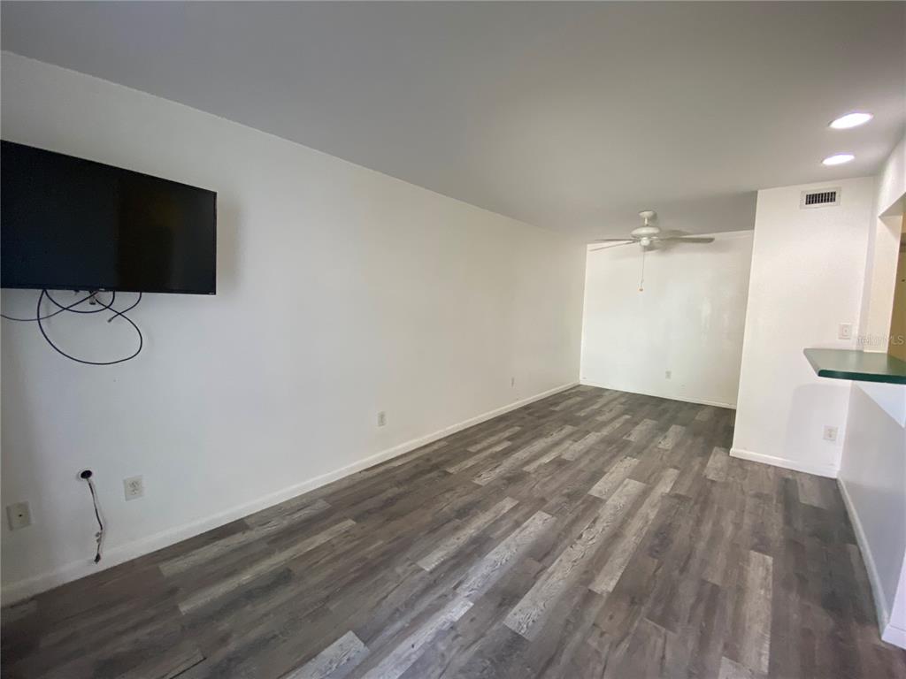 22302 Vick Street, Unit 112 Punta Gorda, FL 33980 - Photo 8 of 10 a view of a room with wooden floor and sink