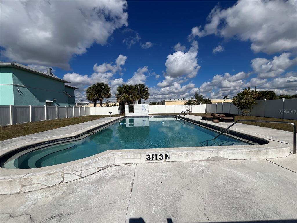 22302 Vick Street, Unit 112 Punta Gorda, FL 33980 - Photo 10 of 10 a view of a swimming pool with a yard in back