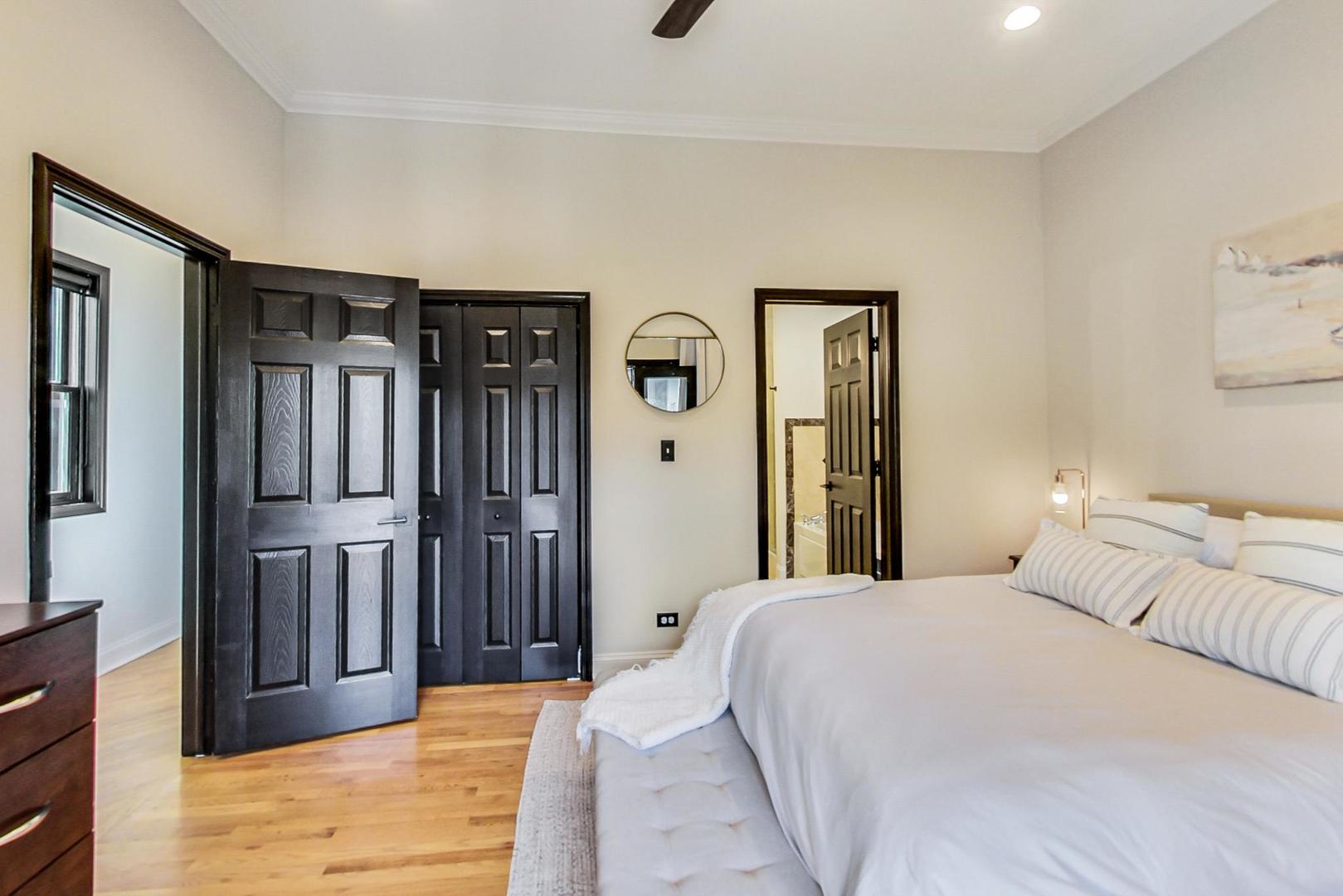 933 West Wolfram Street, Unit 2 Chicago, IL 60657 - Photo 13 of 24 a bedroom with a bed closet and a large mirror