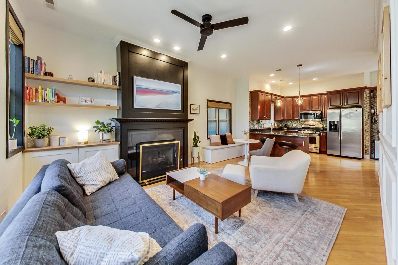 933 West Wolfram Street, Unit 2 Chicago, IL 60657 - Photo 2 of 24 a living room with furniture a fireplace a flat screen tv and kitchen view