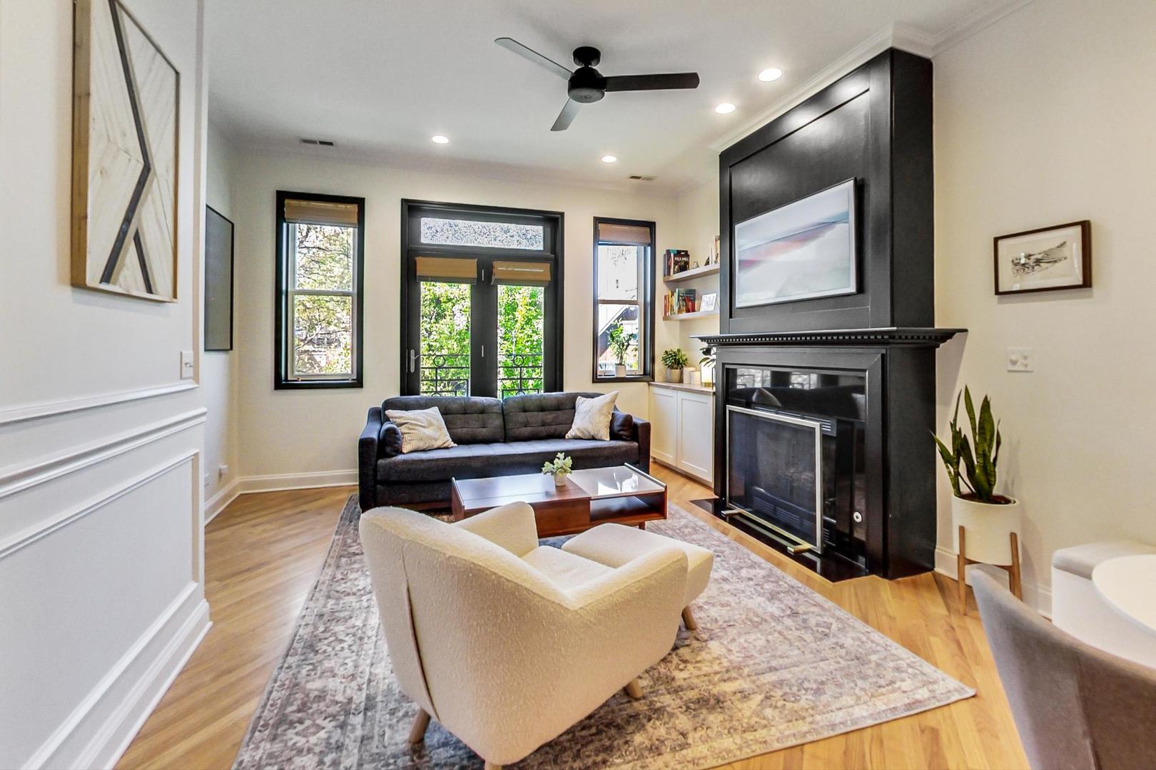 933 West Wolfram Street, Unit 2 Chicago, IL 60657 - Photo 3 of 24 a living room with furniture a flat screen tv and a fireplace