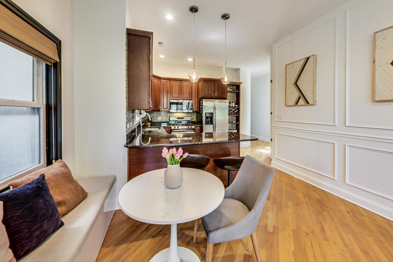 933 West Wolfram Street, Unit 2 Chicago, IL 60657 - Photo 6 of 24 a view of a dining room with furniture and wooden floor