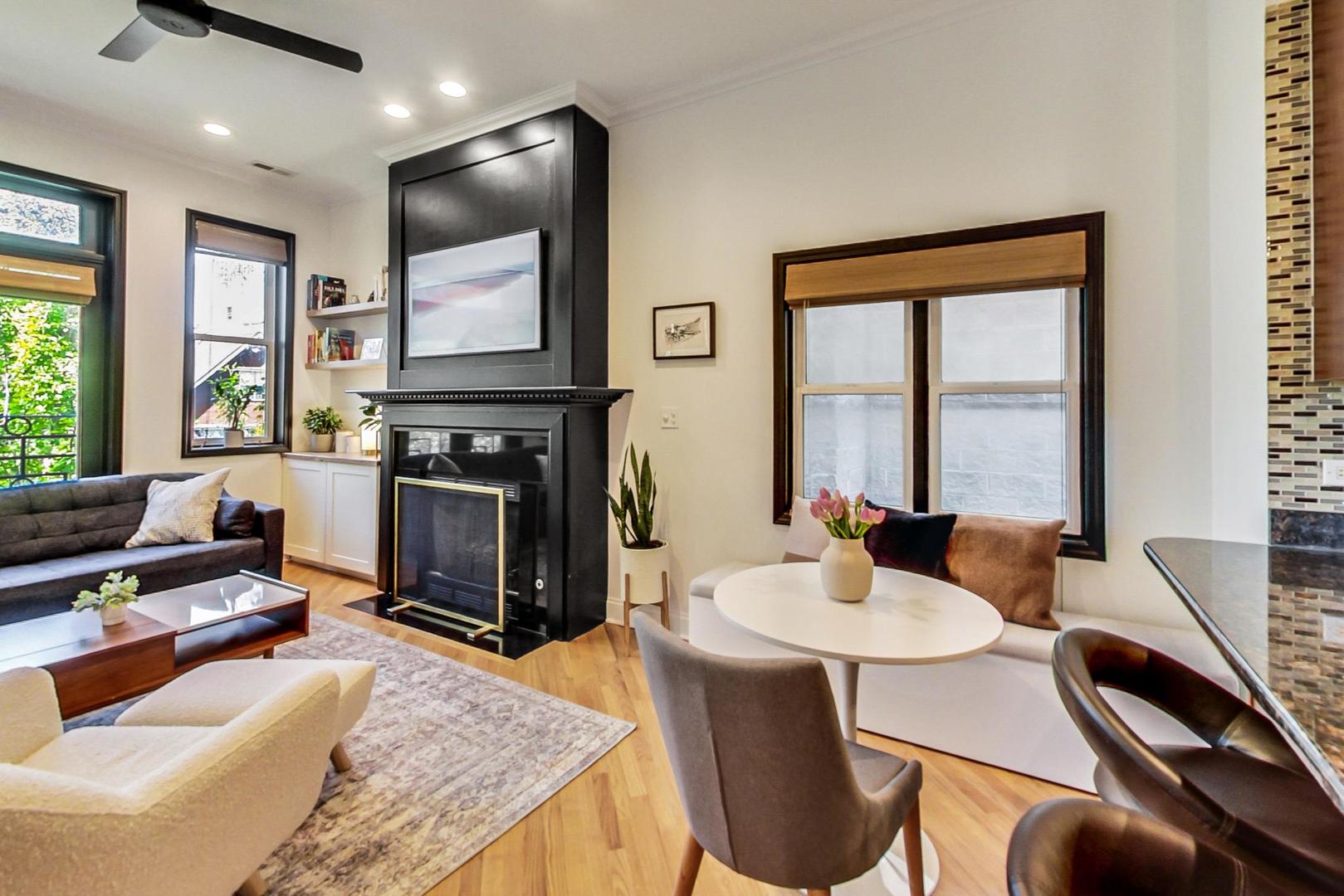 933 West Wolfram Street, Unit 2 Chicago, IL 60657 - Photo 7 of 24 a living room with furniture a flat screen tv and a fireplace