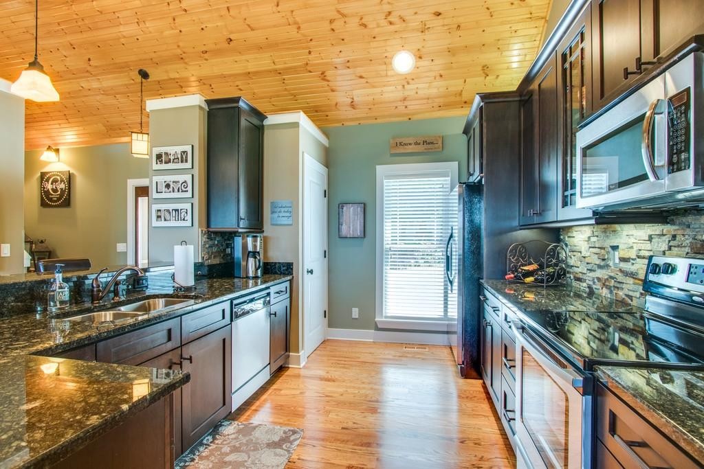 111 Vista Point Road, Unit 111 Silver Point, TN 38582 - Photo 13 of 30 a kitchen with stainless steel appliances granite countertop a stove and a refrigerator
