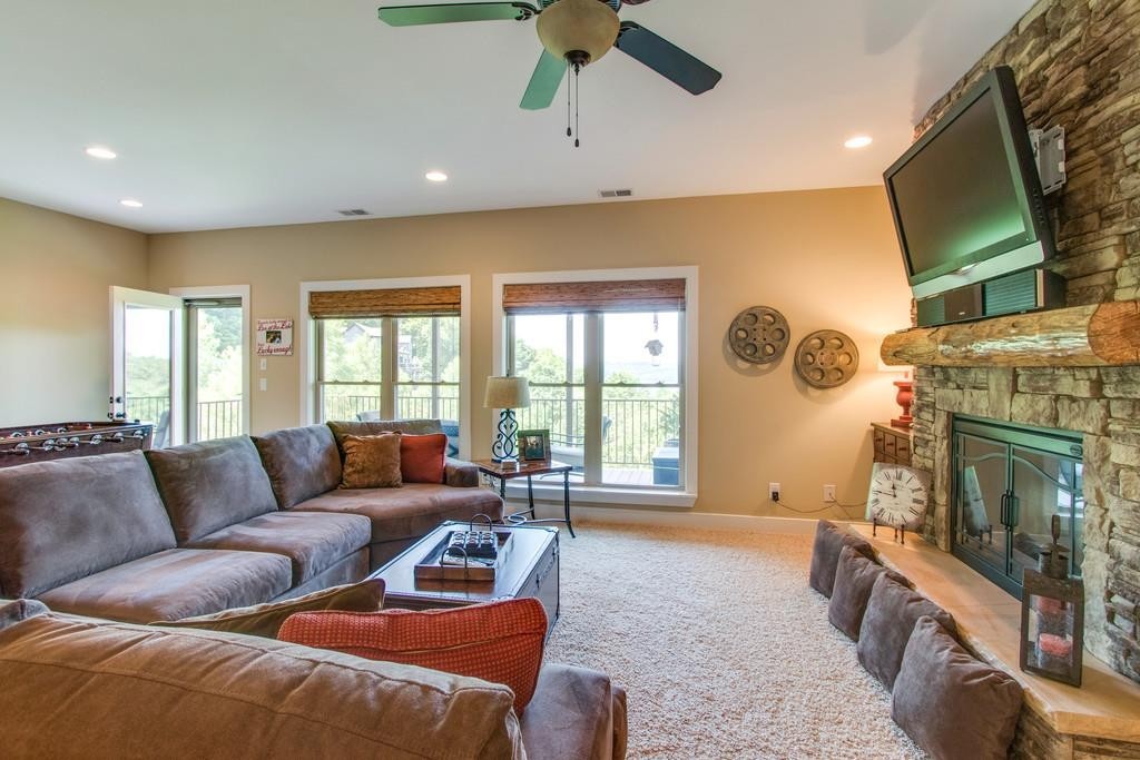111 Vista Point Road, Unit 111 Silver Point, TN 38582 - Photo 20 of 30 a living room with furniture a flat screen tv and a fireplace