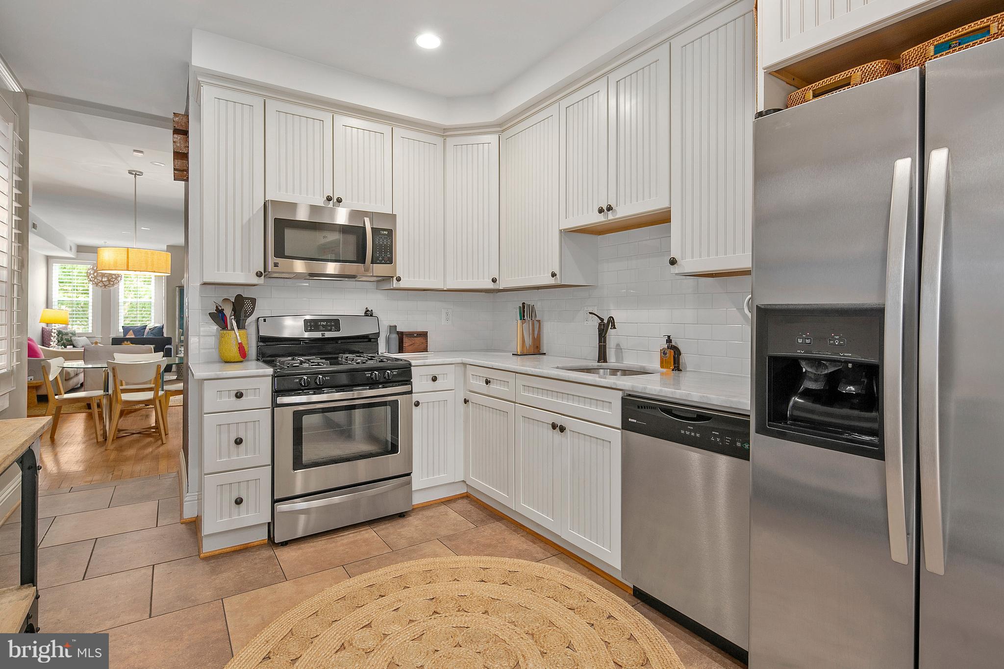 1437 G Street Northeast Washington, DC 20002 - Photo 12 of 24 a kitchen with stainless steel appliances granite countertop a stove a sink and a refrigerator
