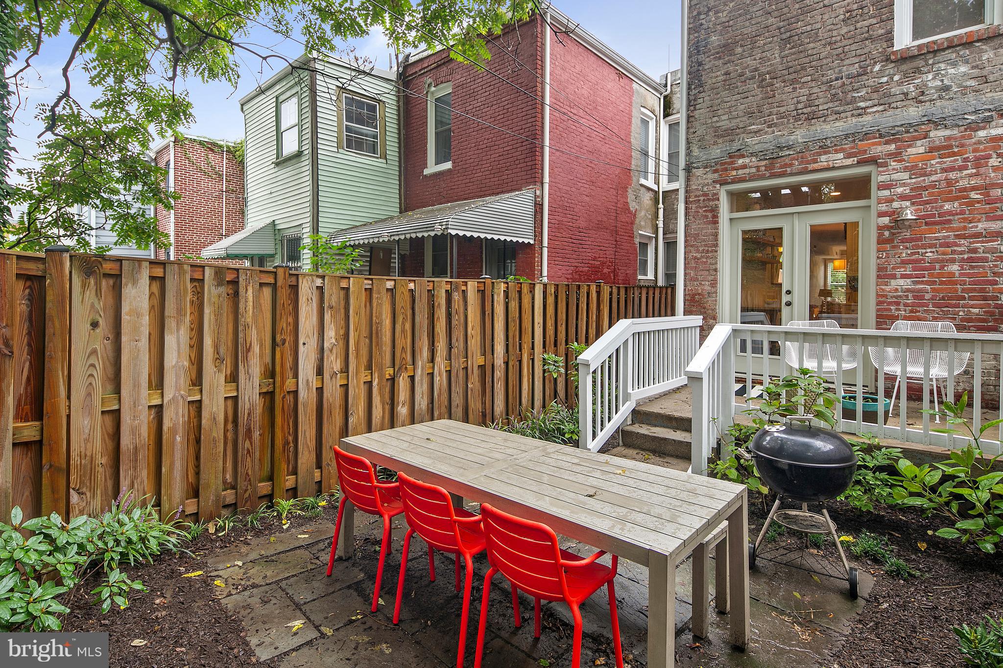 1437 G Street Northeast Washington, DC 20002 - Photo 14 of 24 a view of a patio with table and chairs and potted plants