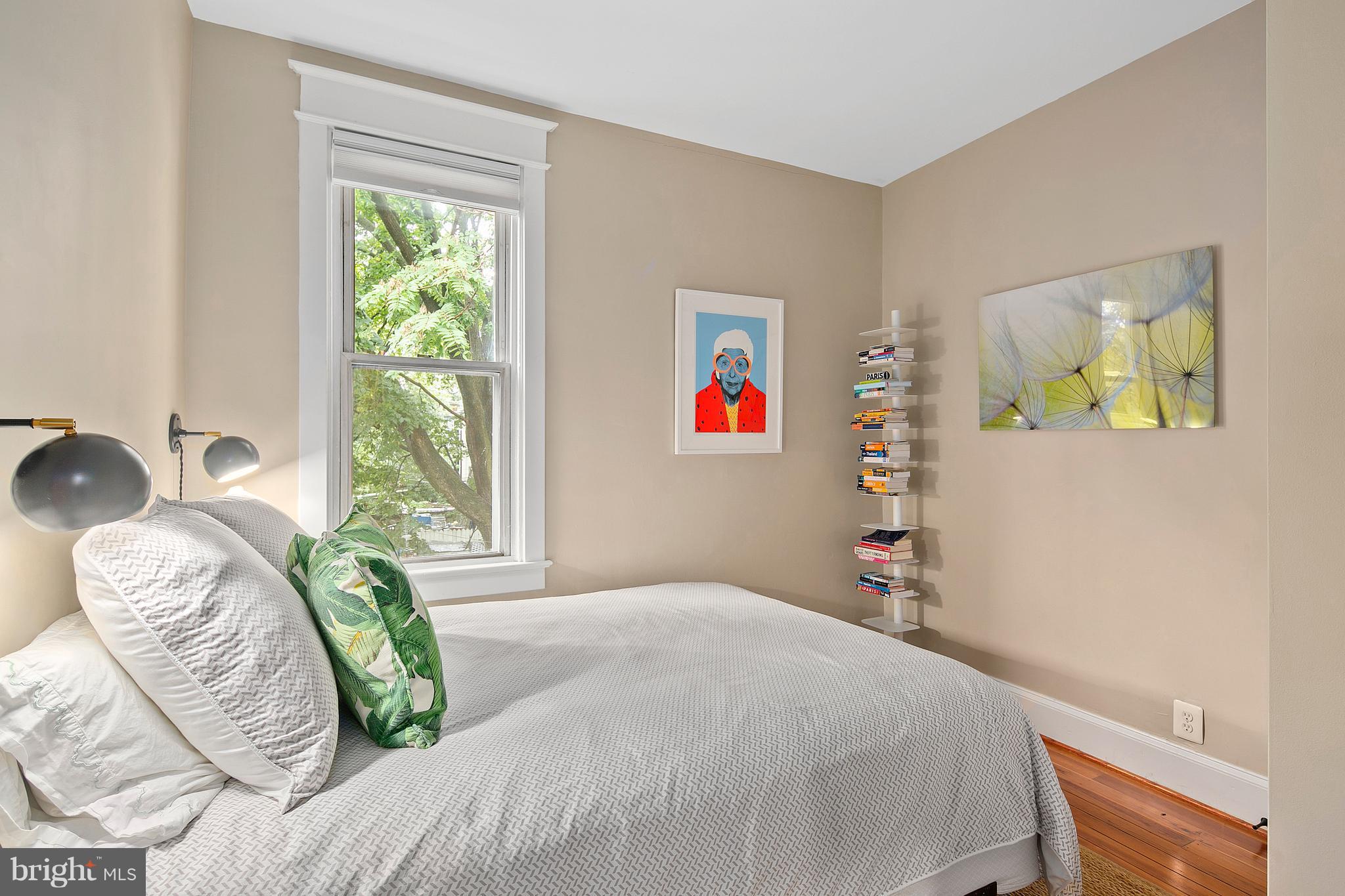 1437 G Street Northeast Washington, DC 20002 - Photo 18 of 24 a bed sitting in a bedroom next to a window
