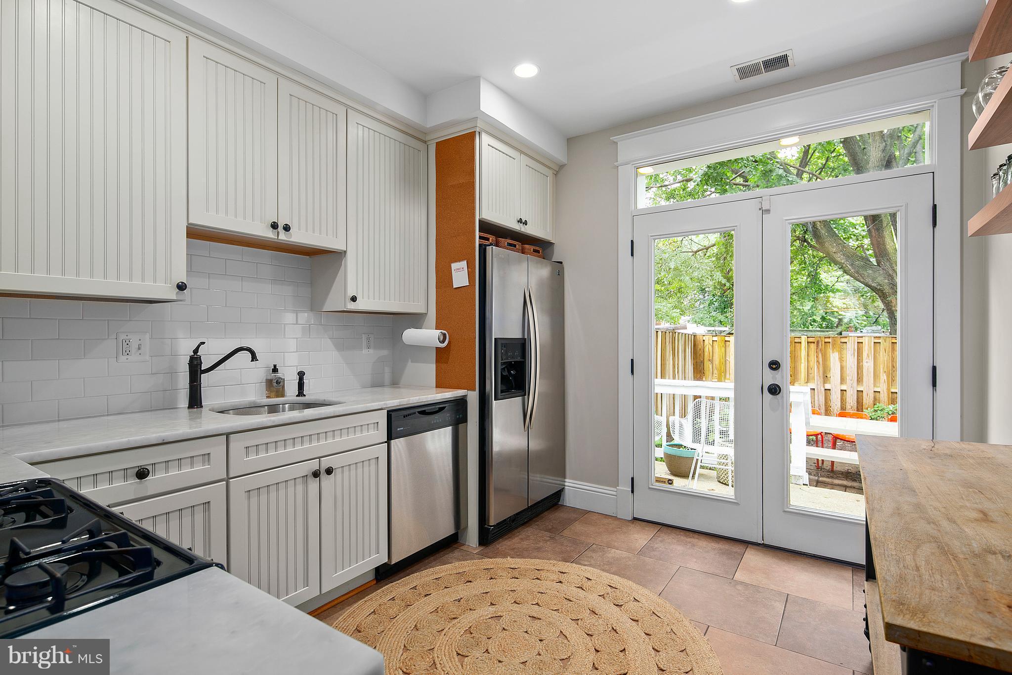 1437 G Street Northeast Washington, DC 20002 - Photo 10 of 24 a kitchen with stainless steel appliances a stove a sink and a refrigerator