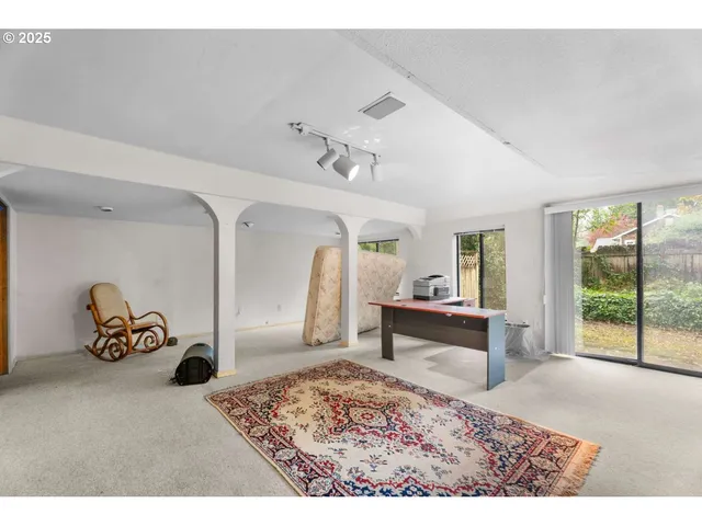 a view of a balcony with wooden floor next to a yard
