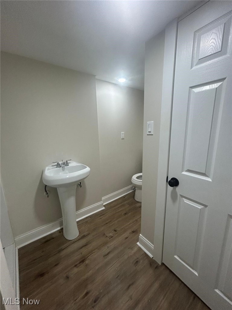 15410 Turney Road Maple Heights, OH 44137 - Photo 31 of 46 Bathroom featuring dark wood-type flooring and baseboards