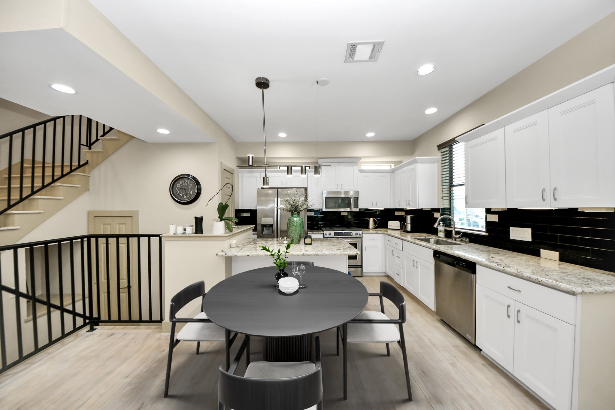 4510 Inker Street, Unit B Houston, TX 77007 - Photo 14 of 43 a kitchen with a table chairs stove and white cabinets