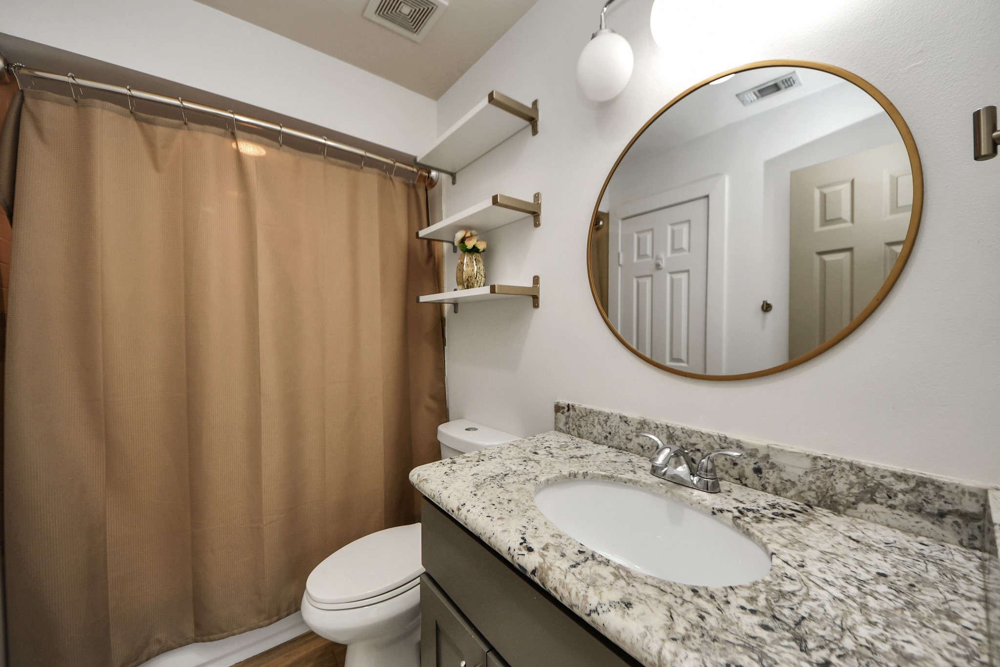 4510 Inker Street, Unit B Houston, TX 77007 - Photo 29 of 43 a bathroom with a granite countertop sink a mirror a toilet and a mirror