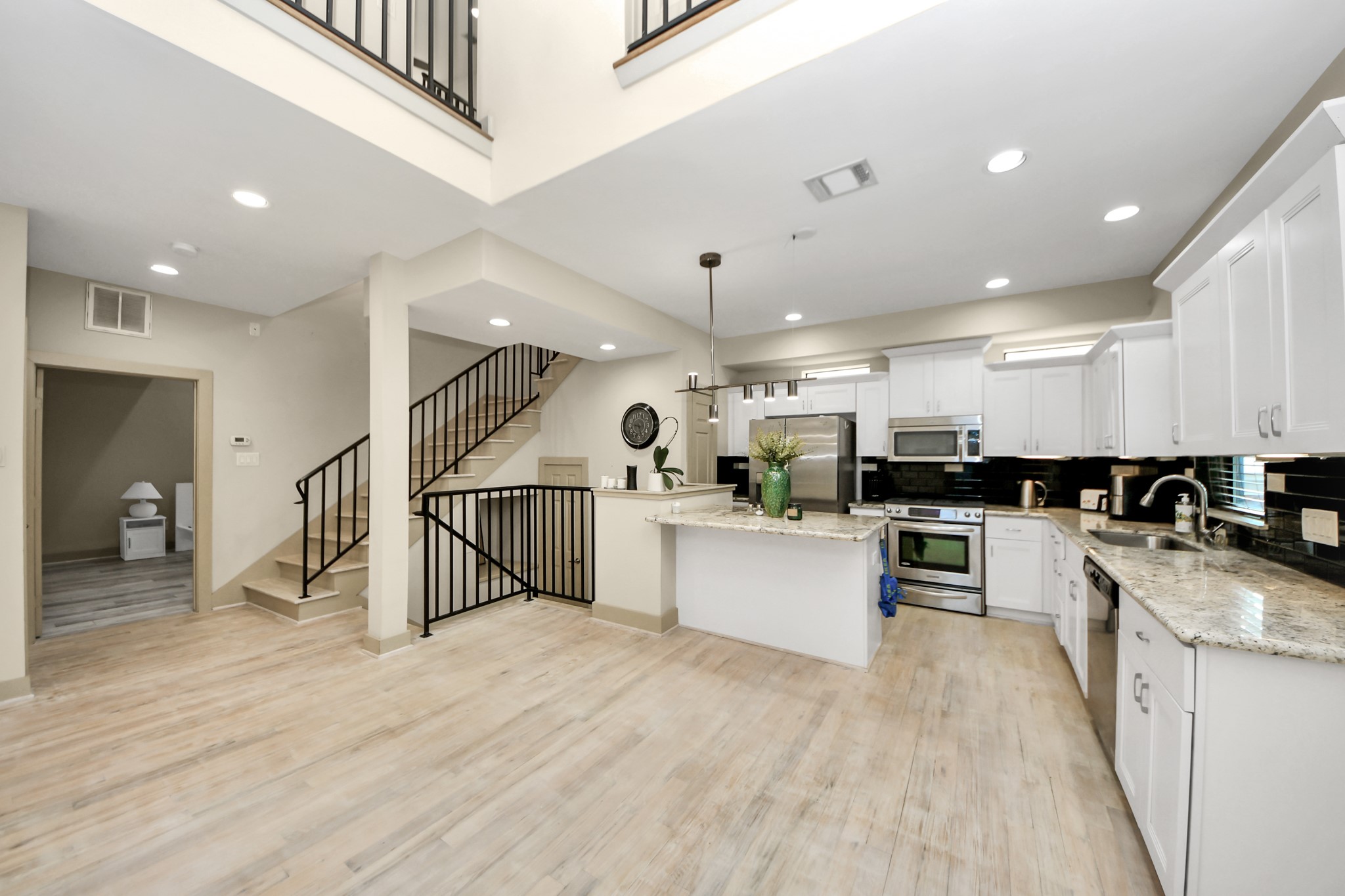 4510 Inker Street, Unit B Houston, TX 77007 - Photo 10 of 43 a kitchen with stainless steel appliances kitchen island sink stove refrigerator and cabinets