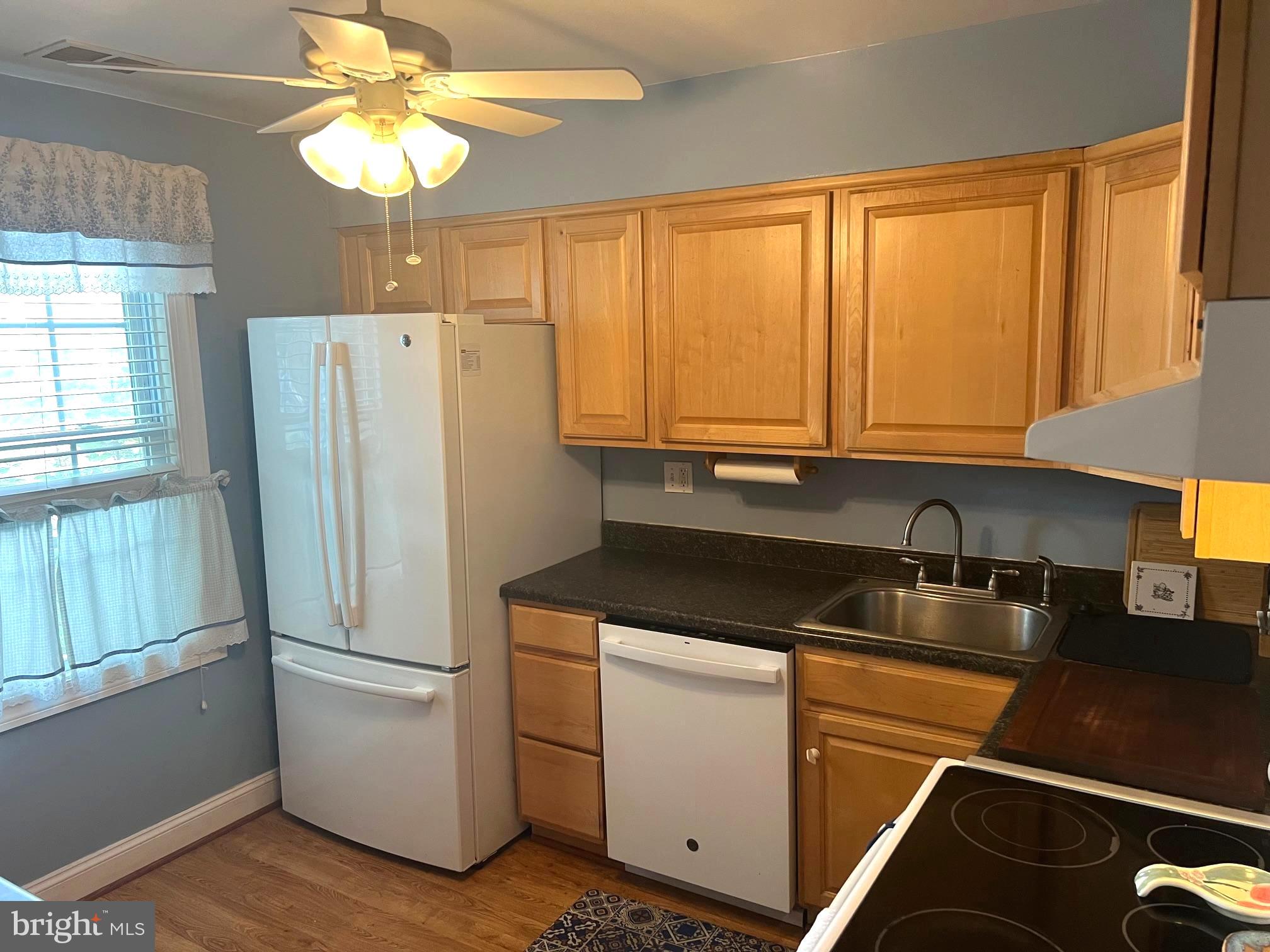 1761 Aberdeen Circle Crofton, MD 21114 - Photo 4 of 33 a kitchen with a refrigerator a sink and cabinets