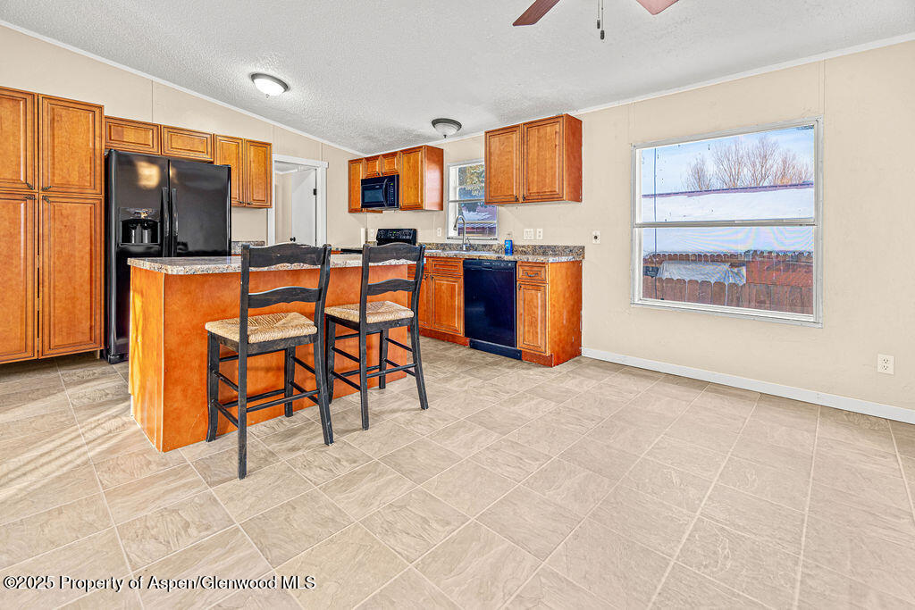 405 Hawthorn Street Craig, CO 81625 - Photo 11 of 35 a view of a workspace with furniture and a kitchen