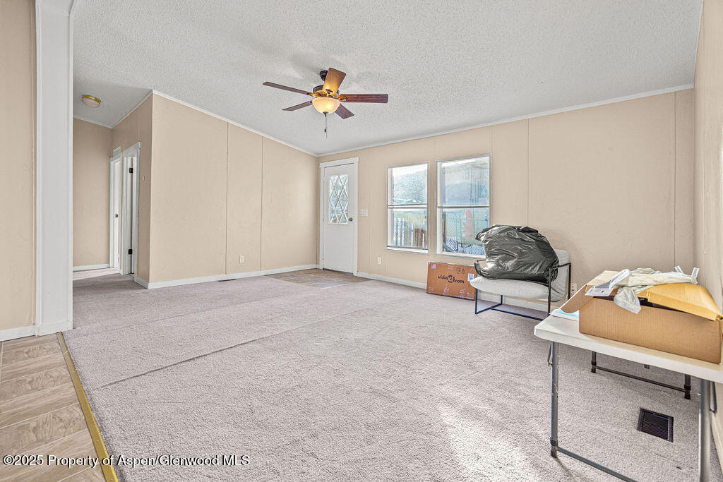 405 Hawthorn Street Craig, CO 81625 - Photo 14 of 35 a living room with furniture and a window