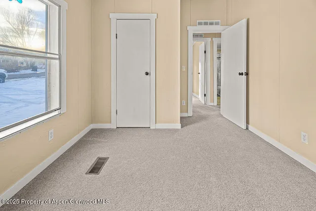 a view of an empty room with a window