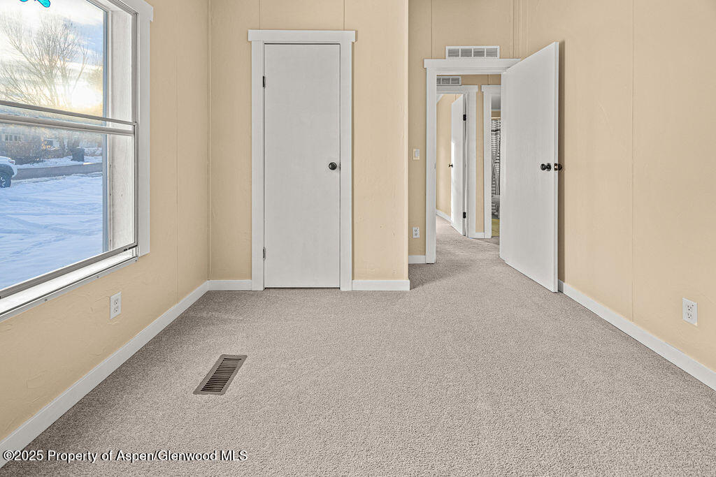 405 Hawthorn Street Craig, CO 81625 - Photo 18 of 35 a view of an empty room with a window