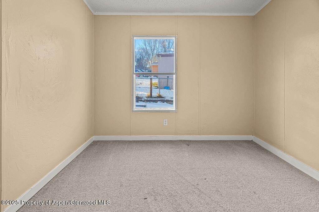 405 Hawthorn Street Craig, CO 81625 - Photo 20 of 35 an empty room with a window