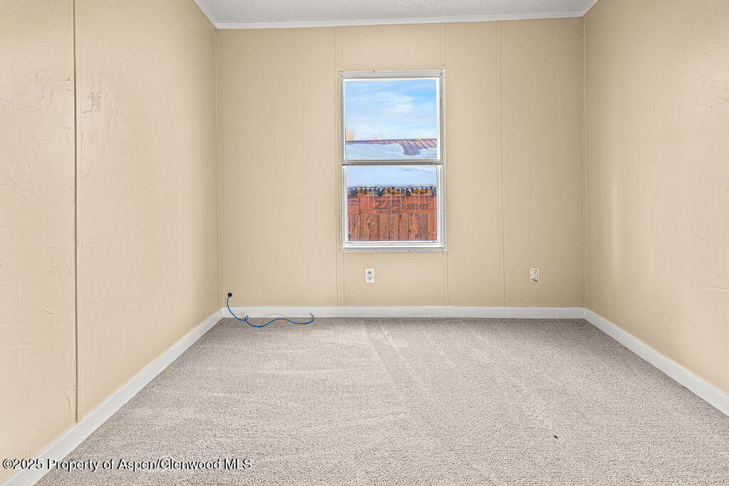 405 Hawthorn Street Craig, CO 81625 - Photo 22 of 35 a view of an empty room with a window