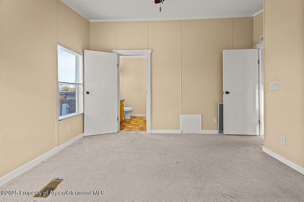 405 Hawthorn Street Craig, CO 81625 - Photo 27 of 35 a view of an empty room with wooden floor