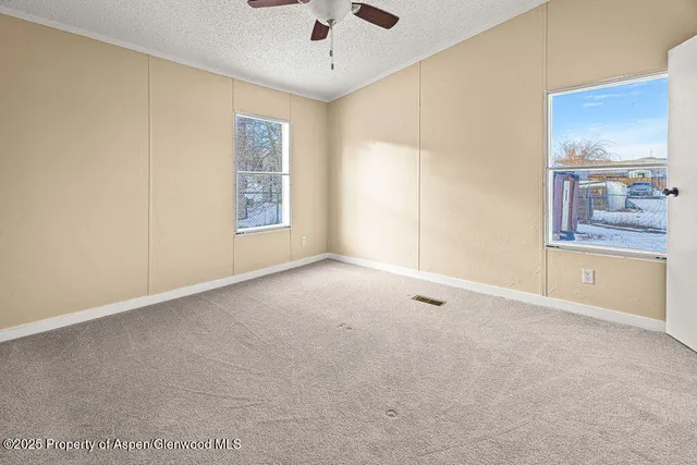 a view of a room with wooden floor and windows