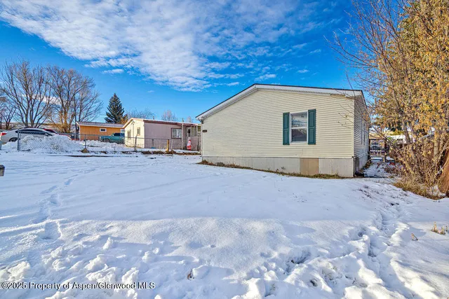 a view of a house with a snow in the yard