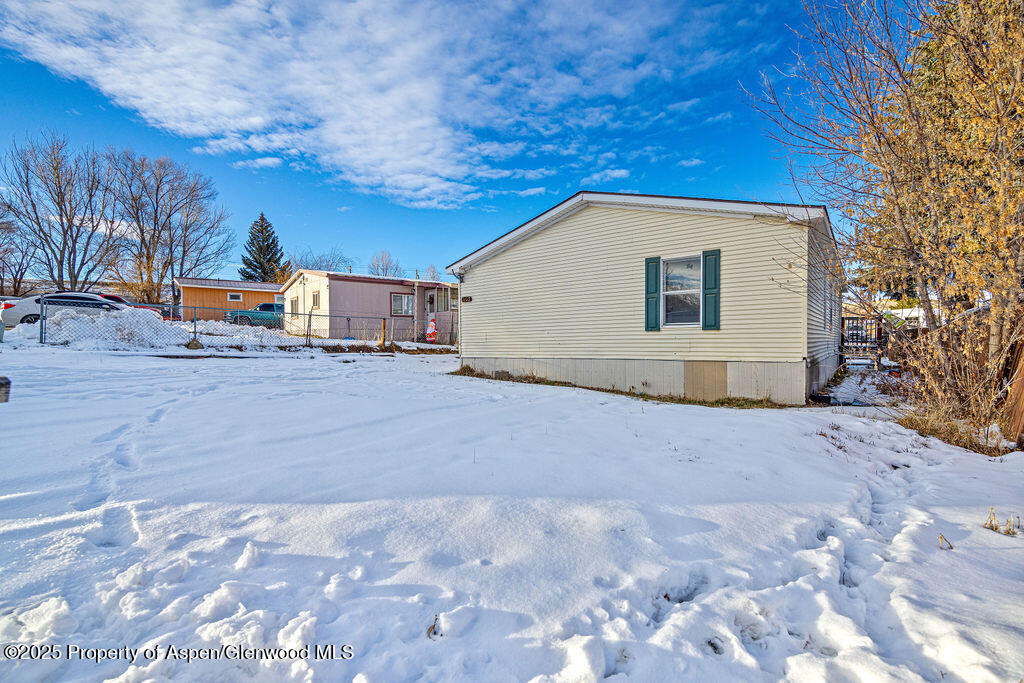 405 Hawthorn Street Craig, CO 81625 - Photo 3 of 35 a view of a house with a snow in the yard