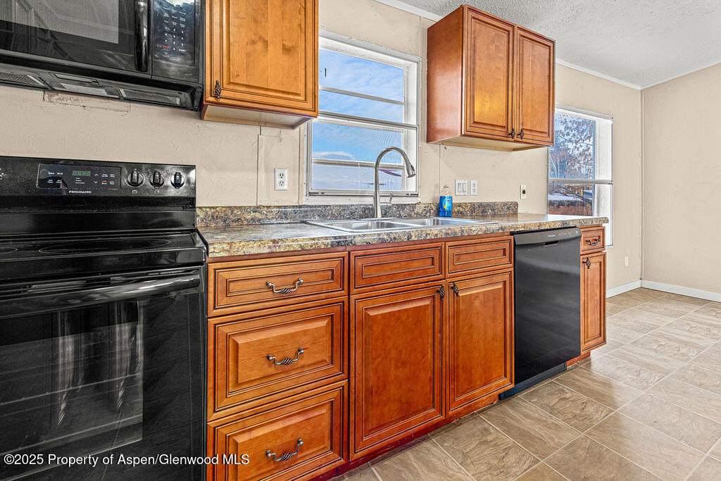 405 Hawthorn Street Craig, CO 81625 - Photo 7 of 35 a kitchen with granite countertop stainless steel appliances and cabinets