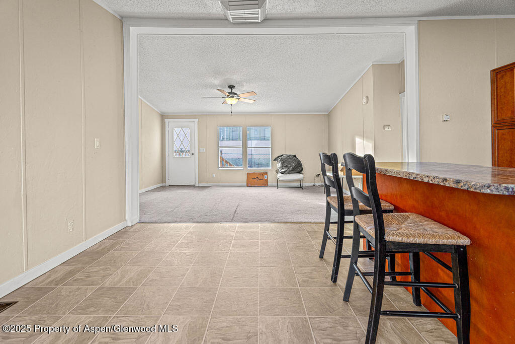 405 Hawthorn Street Craig, CO 81625 - Photo 9 of 35 a living room with a dining table and chairs