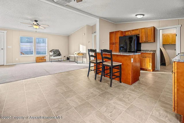 a living room with patio furniture and a flat screen tv