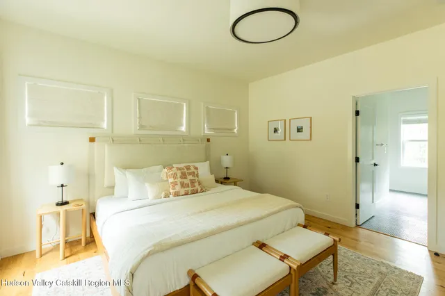 a bedroom with a bed and chandelier