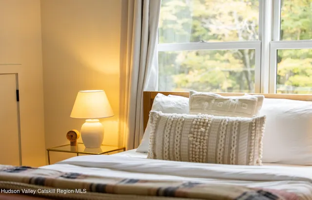 a bedroom with a bed and a night stand