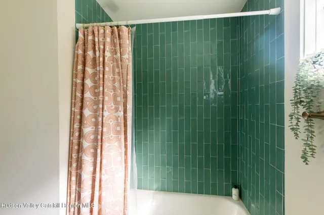 a bathroom with a shower and a sink