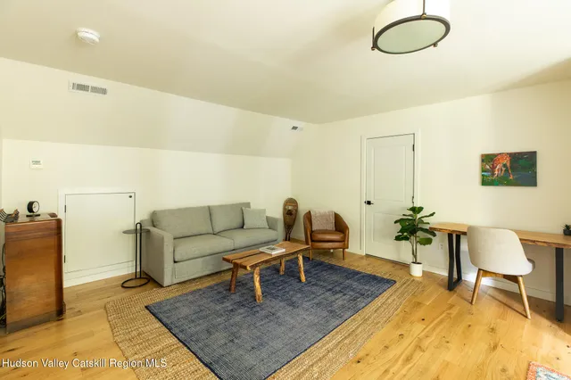 a living room with furniture rug and a table