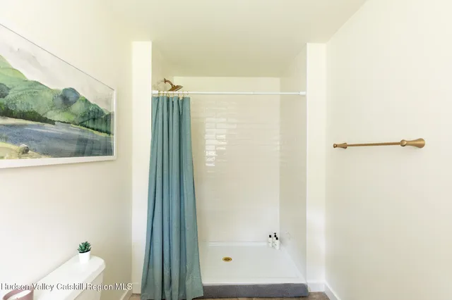 a balcony with wooden floor and outdoor seating