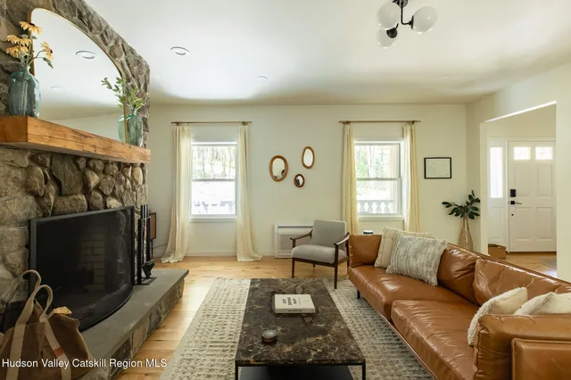 a living room with furniture a fireplace and a flat screen tv