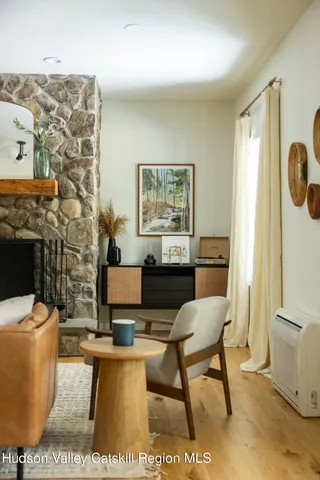 a living room with furniture a rug and a fireplace