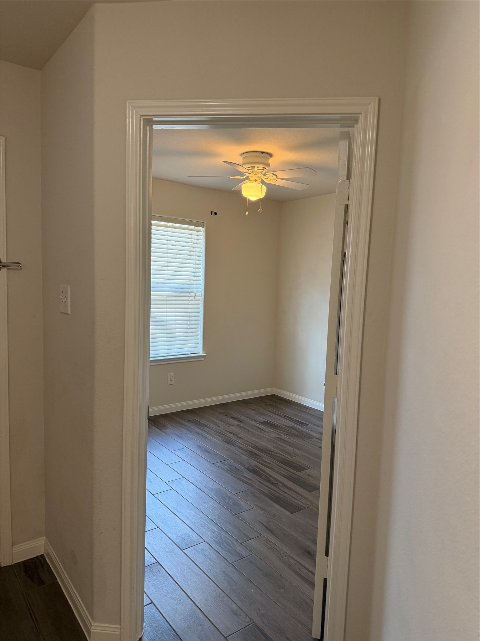 9919 Opal Rock Drive Rosharon, TX 77583 - Photo 12 of 21 a view of empty room with window and wooden floor