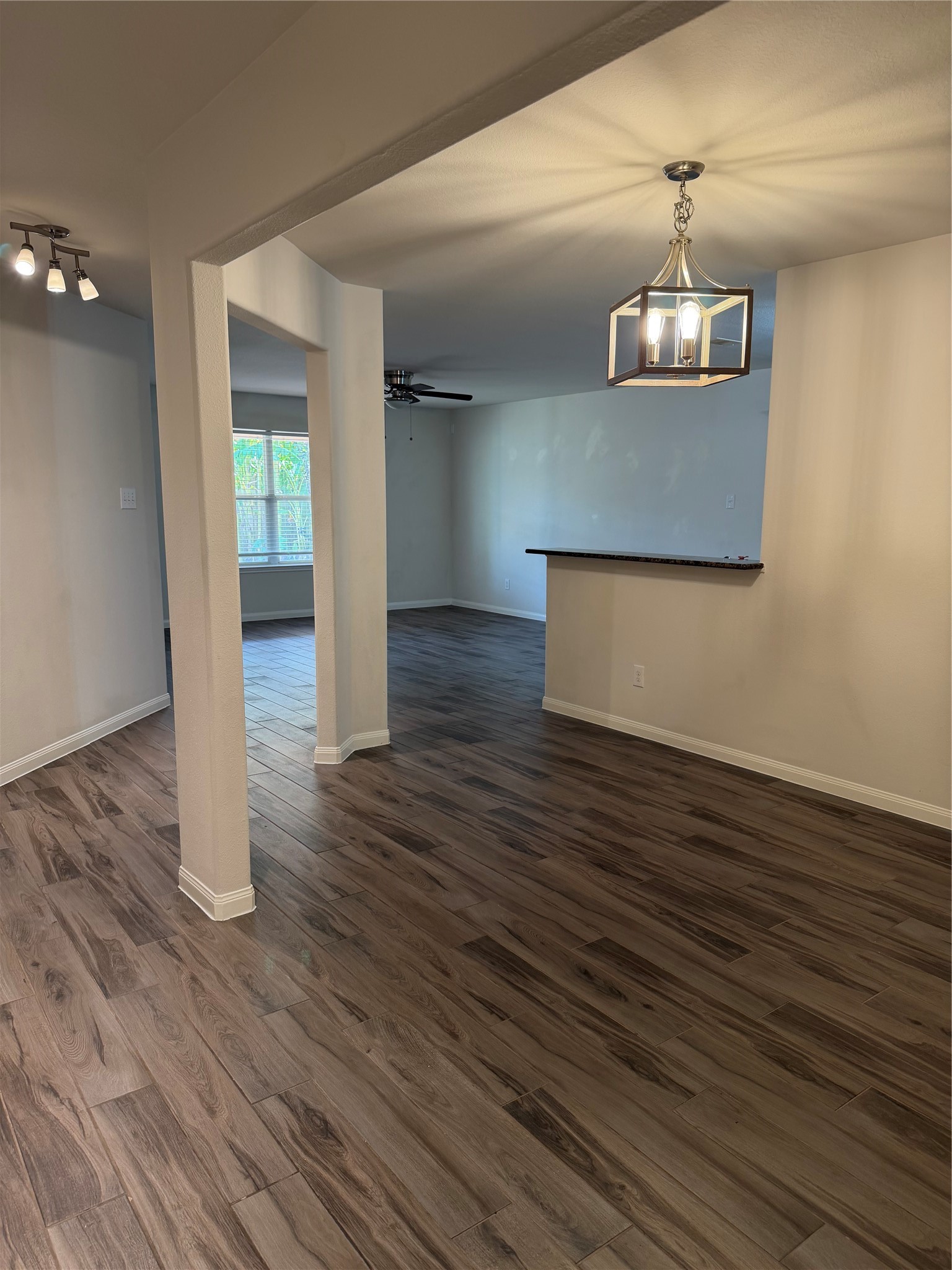 9919 Opal Rock Drive Rosharon, TX 77583 - Photo 13 of 21 an empty room with wooden floor chandelier and entryway