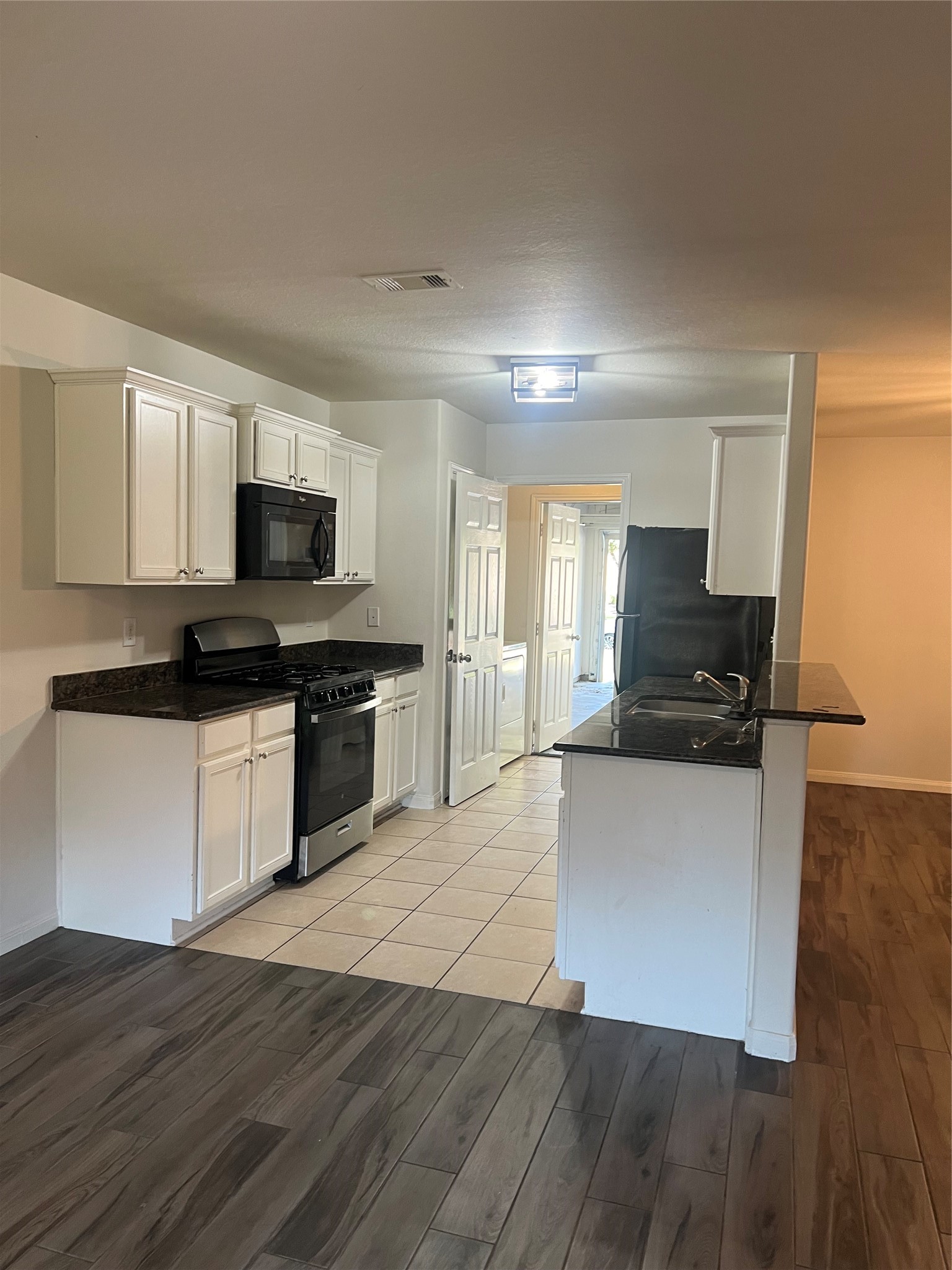 9919 Opal Rock Drive Rosharon, TX 77583 - Photo 2 of 21 a kitchen with granite countertop a refrigerator and a stove top oven