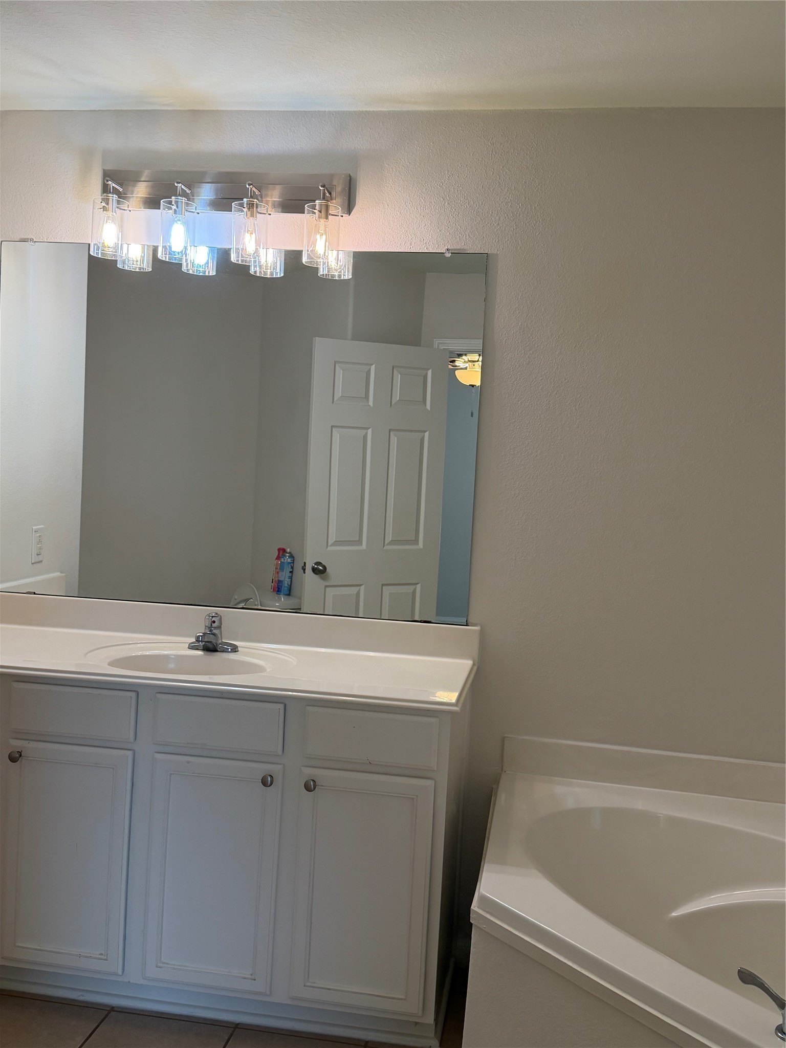 9919 Opal Rock Drive Rosharon, TX 77583 - Photo 7 of 21 a bathroom with a sink a large mirror and a bathtub