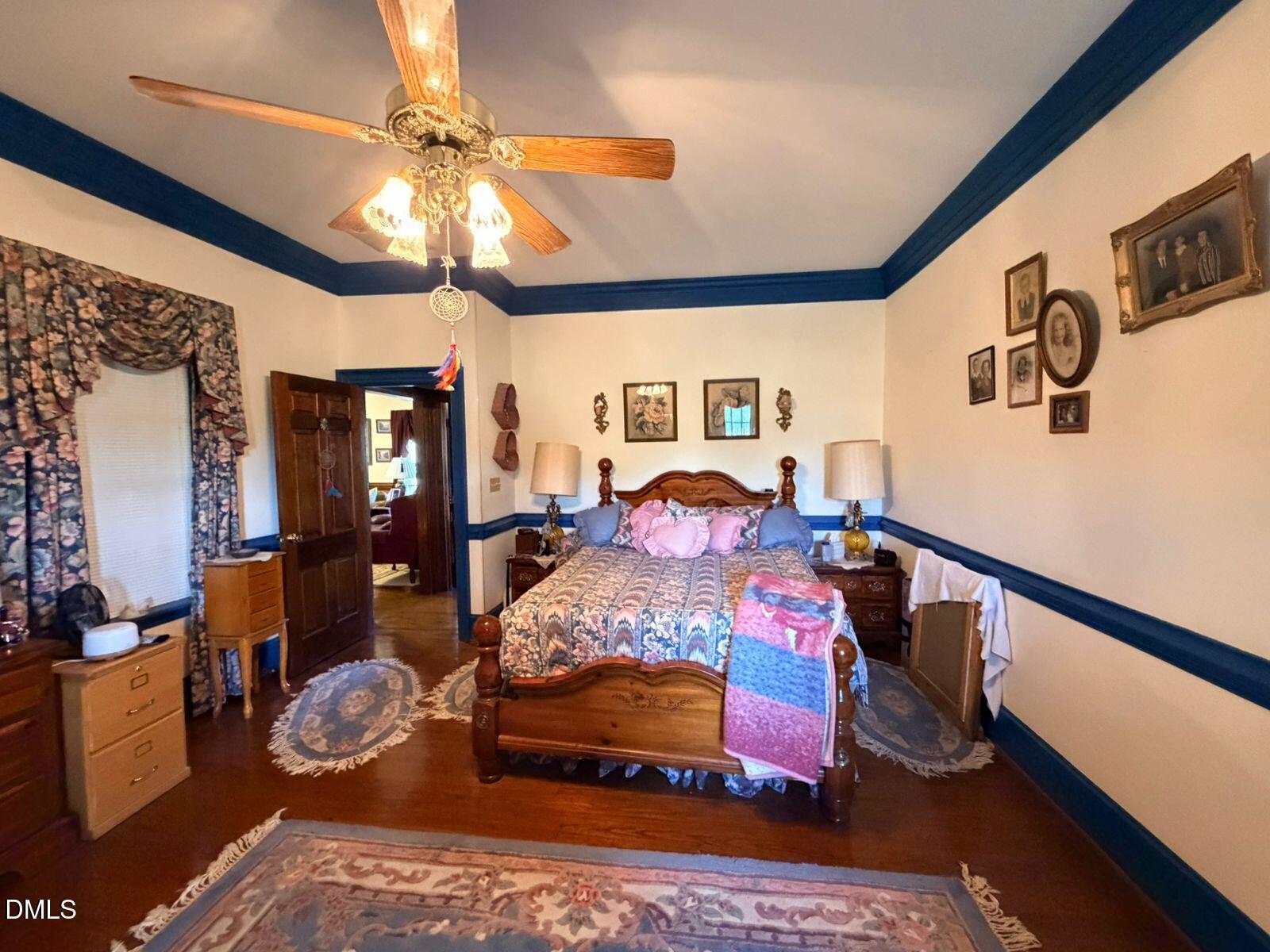 9222 Midway Road Bailey, NC 27807 - Photo 18 of 35 a bed room with furniture and a chandelier