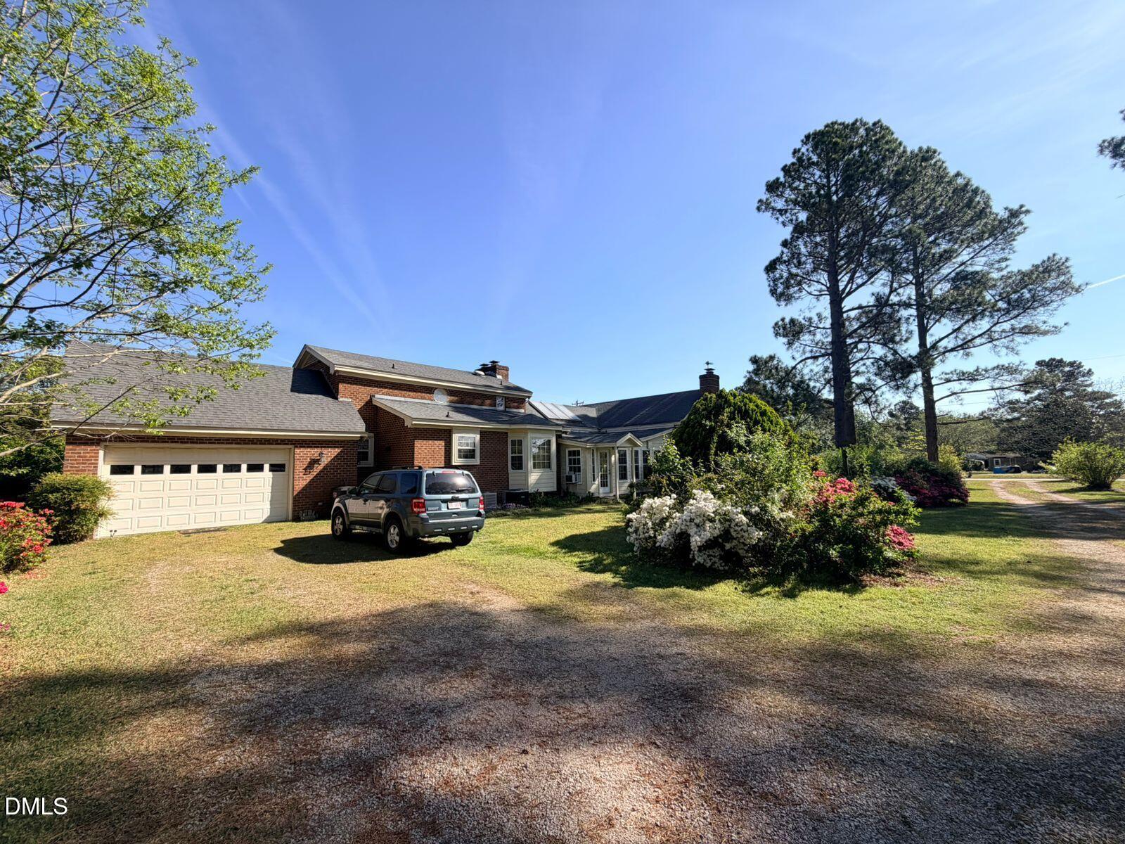 9222 Midway Road Bailey, NC 27807 - Photo 2 of 35 a view of a house with a yard and sitting area