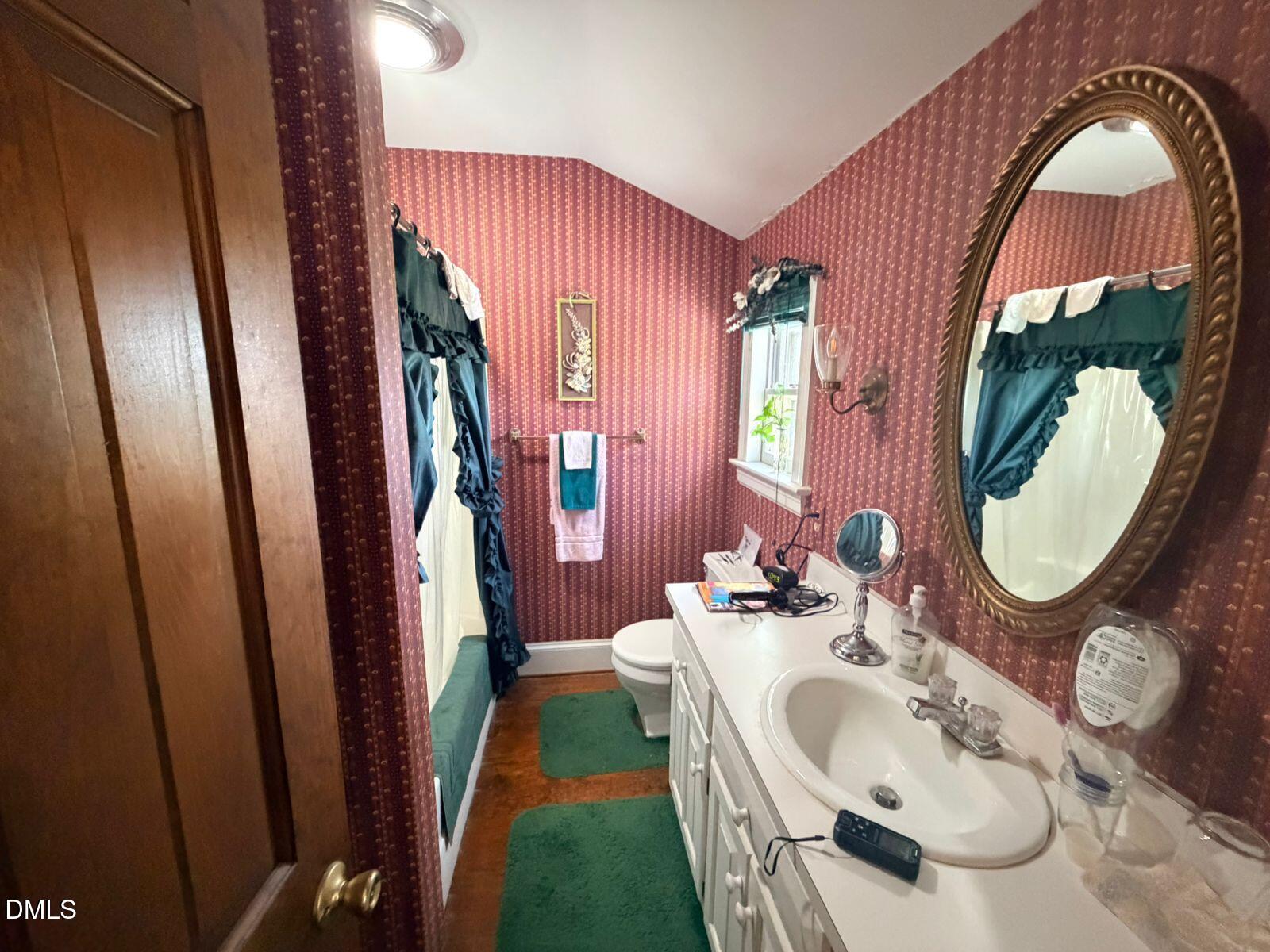 9222 Midway Road Bailey, NC 27807 - Photo 25 of 35 a bathroom with a sink a mirror and bathtub