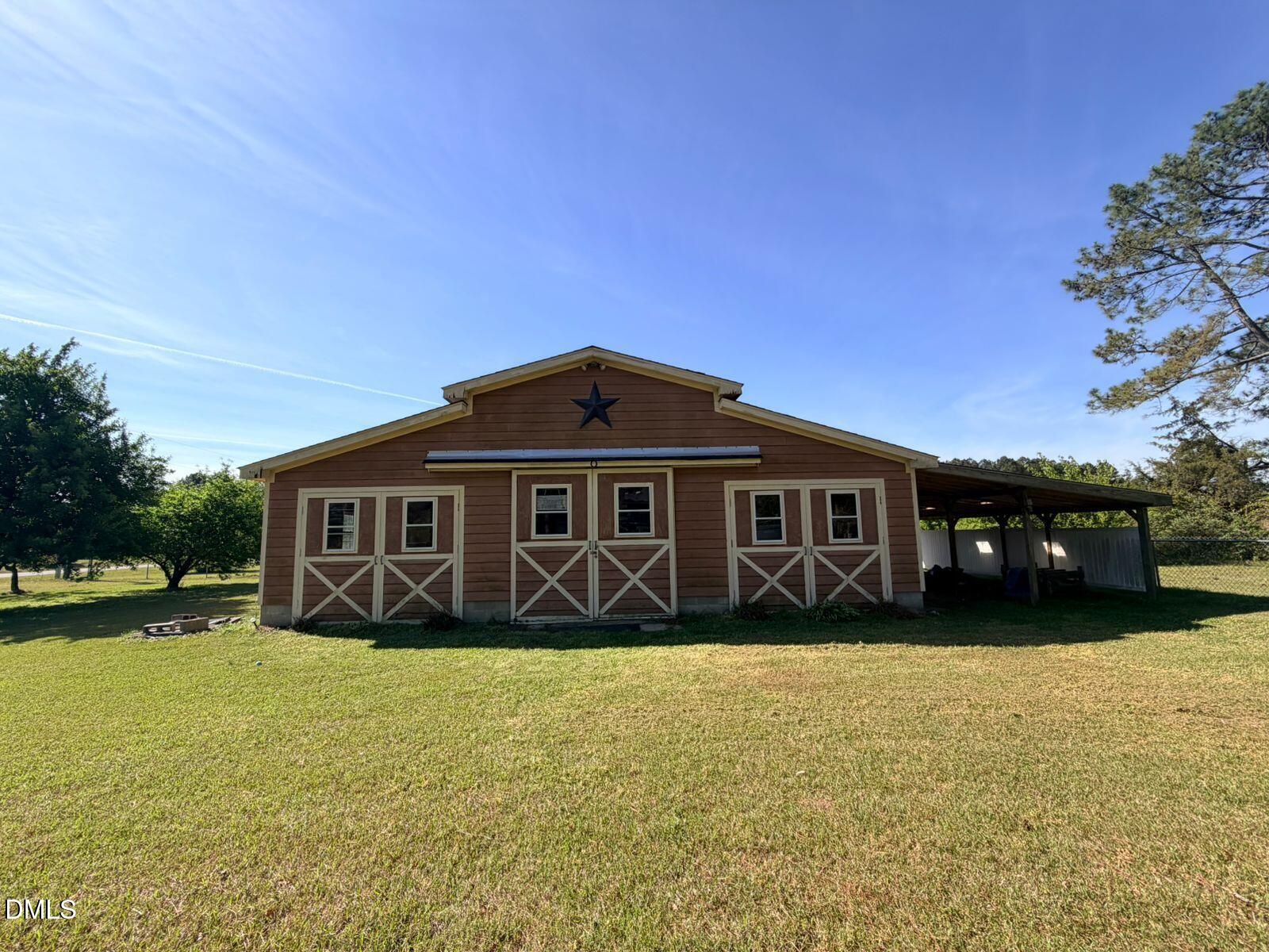 9222 Midway Road Bailey, NC 27807 - Photo 27 of 35 a front view of a house with a yard