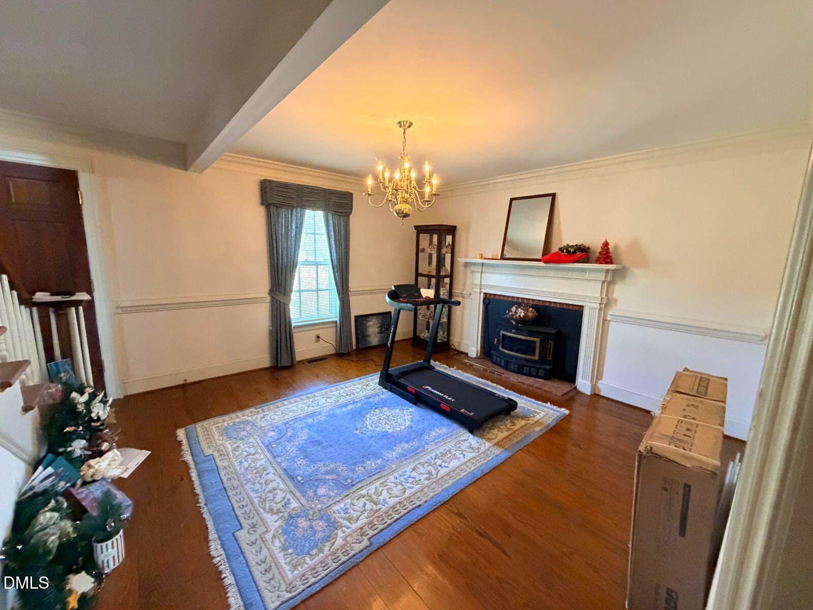 9222 Midway Road Bailey, NC 27807 - Photo 6 of 35 a living room with furniture a fireplace and a flat screen tv